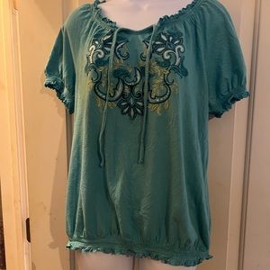 Green off the shoulder blouse. Straps hang in front. Design on front of shirt